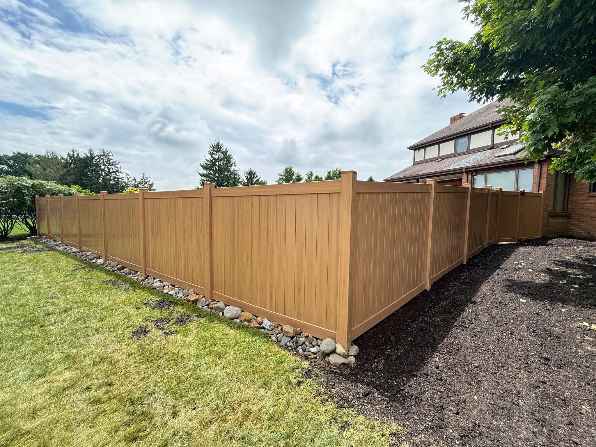 Backyard vinyl privacy fence installation wrapping a Pittsburgh home
