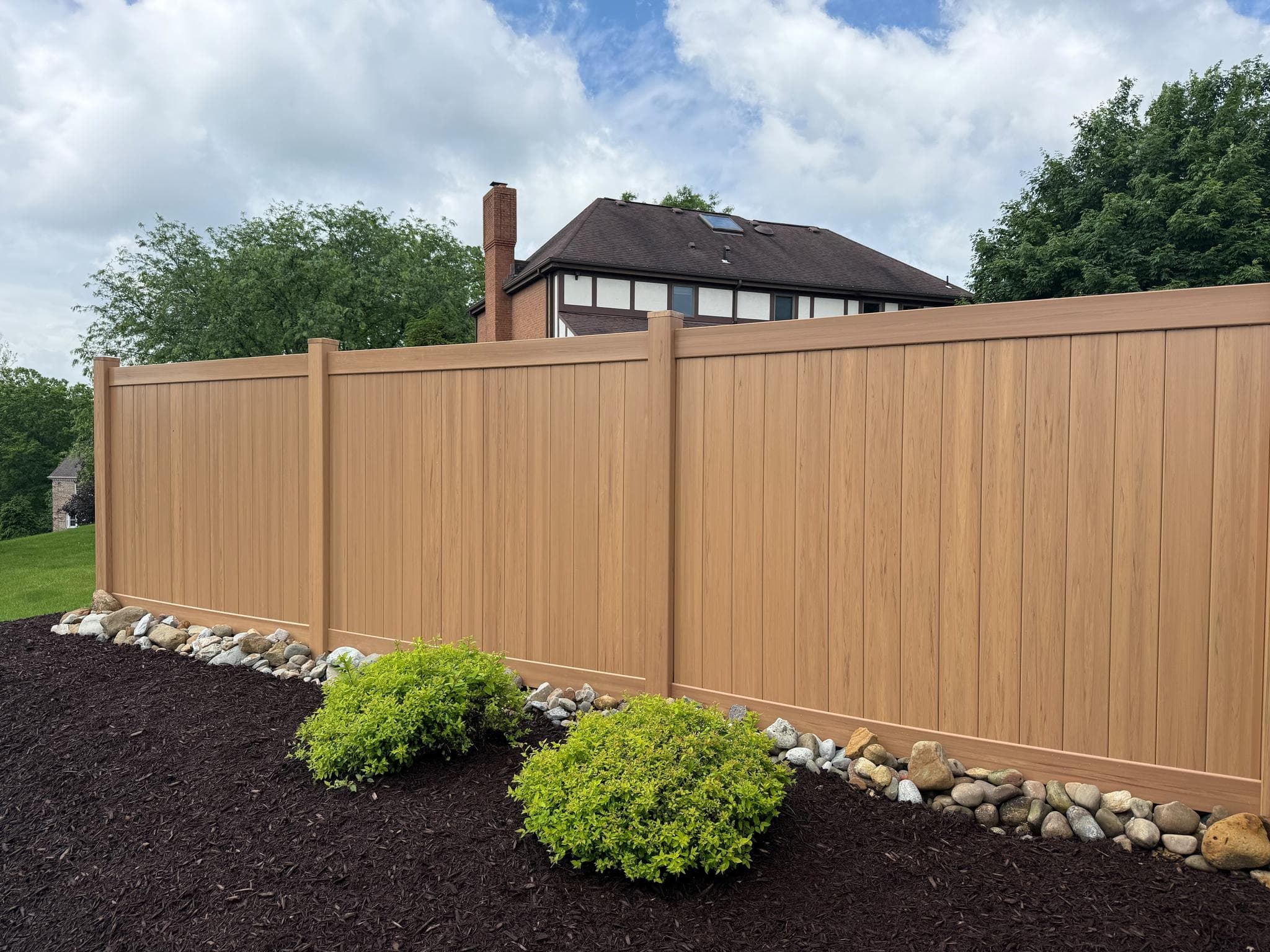 Vinyl privacy fence with fresh landscaping and shrub beds in Pittsburgh